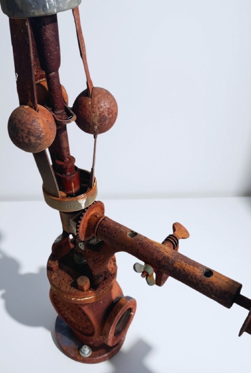Antique flyball governor covered in heavy rust, before laser cleaning